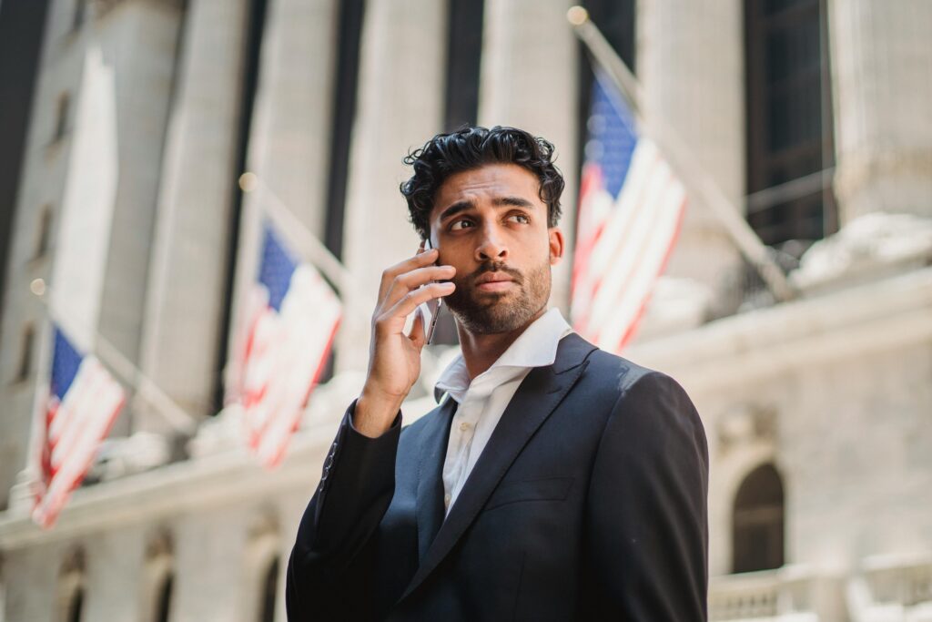 Shallow Focus of a Man in Black Suit while Making a Phone Call